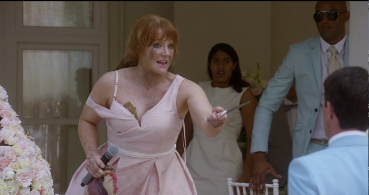 Lacey threatening the guests with a knife